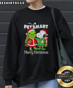 Top PetSmart x Grinch and Snoopy Merry Christmas sweatshirt featuring festive designs for holiday cheer.