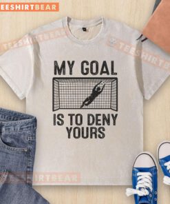 Funny soccer goalie meme on a washed t-shirt: 'My goal is to deny yours' - perfect for sports fans and humor lovers.