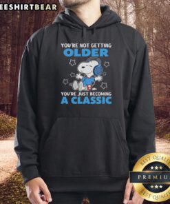 Awesome Snoopy hoodie with 'You're Not Getting Older, You're Just Becoming A Classic' design in vibrant colors.