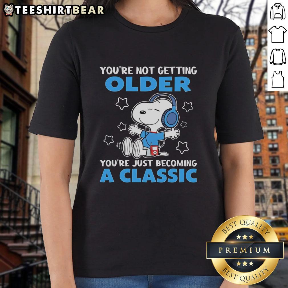 Alt Text: Awesome Snoopy tee for ladies with 'You're Not Getting Older, You're Just Becoming A Classic' design.