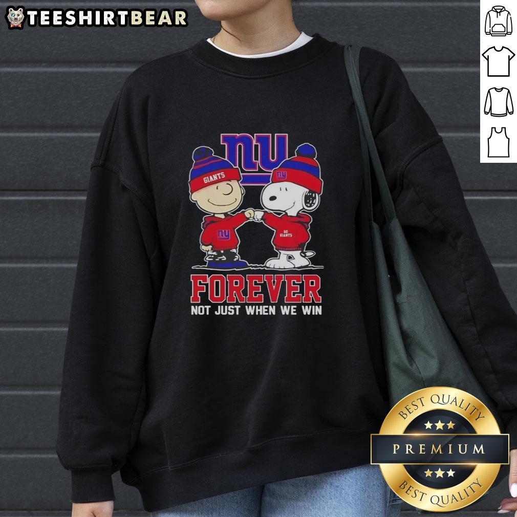 Cute Peanut Snoopy and Charlie Brown on a New York Giants sweatshirt, celebrating fandom all year round.