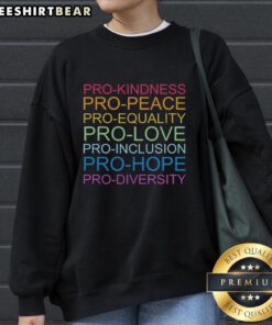 Cozy sweatshirt featuring 'Kindness, Peace, Equality, Love, Inclusion, Hope, Diversity' slogans for a positive message.