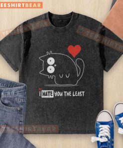 Official 'I Hate You The Least' washed T-shirt displayed on a wooden background, showcasing its unique design.