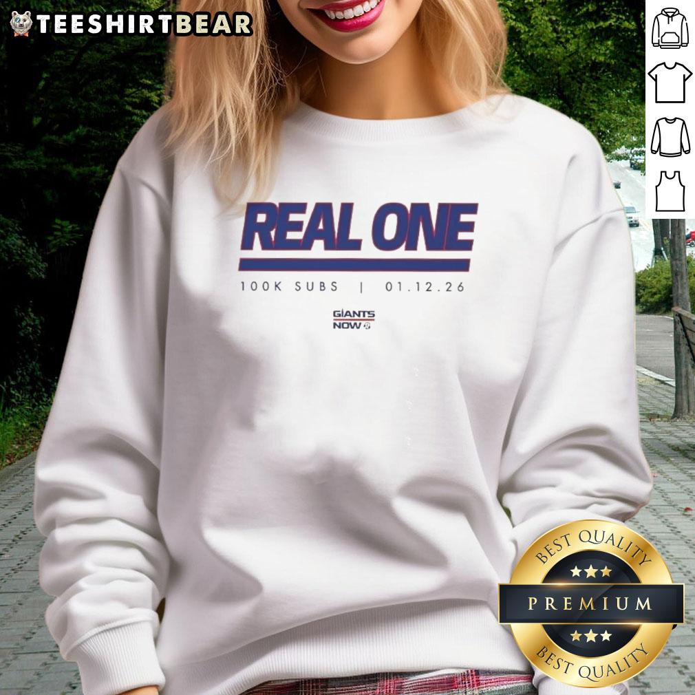 Alt Text: Official New York Giants Real One K Subs Sweatshirt featuring team logo and vibrant colors, perfect for fans.