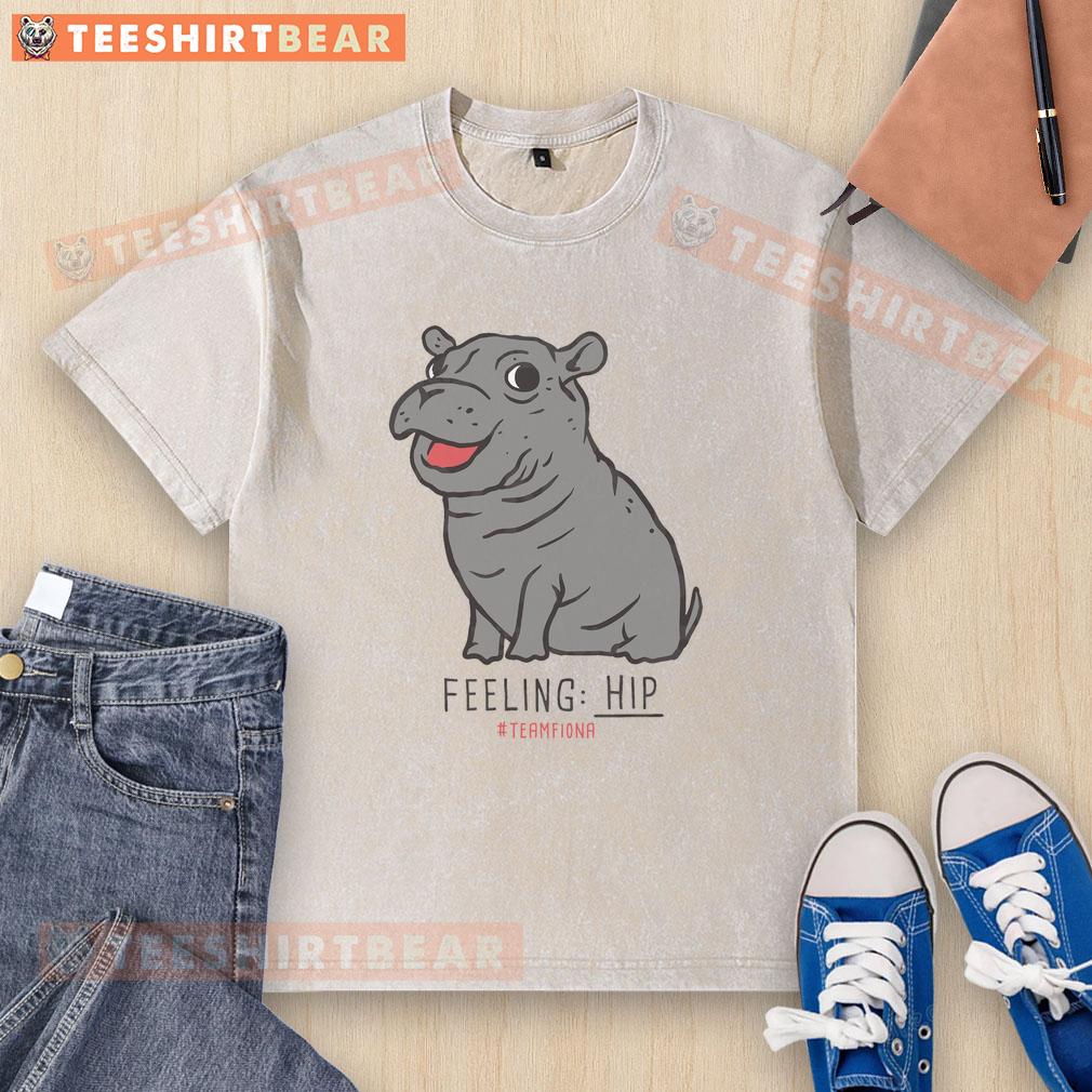 Alt Text: Premium Fiona the Hippo Feeling Hip Washed T-Shirt in light blue, featuring a playful hippo graphic design.