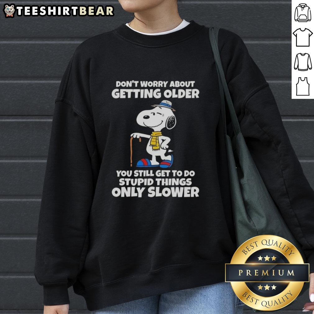 Alt Text: Pretty Snoopy sweatshirt with 'Don't Worry About Getting Older, You Still Get to Do Stupid Things, Only Slower' slogan.