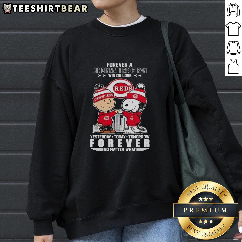 Top Charlie Brown fist bump with Snoopy, celebrating Cincinnati Reds fandom in a win or lose sweatshirt design.