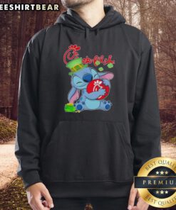 Alt Text: Cute Stitch wearing a St. Patrick's hoodie with Chick-fil-A logo, perfect for festive celebrations and fans.