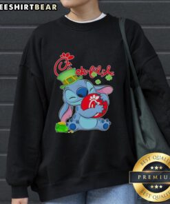 Alt Text: Cute Stitch sweatshirt featuring St. Patrick's Day design and Chick-fil-A logo, perfect for festive wear.