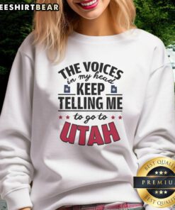 Funny sweatshirt featuring the phrase 'The Voices In My Head Keep Telling Me To Go To Utah' in playful typography.