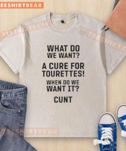 Stylish washed t-shirt featuring bold text: 'Hot - What Do We Want? A Cure For Tourettes! When Do We Want It?' - perfect for awareness.