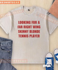Skinny blonde female tennis player in a washed t-shirt, showcasing a stylish look at a tennis match.