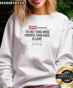 Alt Text: Bad Bunny wearing The Only Thing More Powerful Than Hate Is Love sweatshirt at Levi's Stadium for his concert.