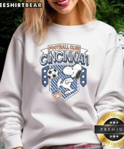 Official Peanuts Snoopy X FC Cincinnati Sweatshirt featuring Snoopy in team colors for fans and collectors.