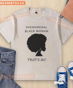 Black woman wearing a 'Top Phenomenal Woman' washed t-shirt, exuding confidence and style in a casual setting.