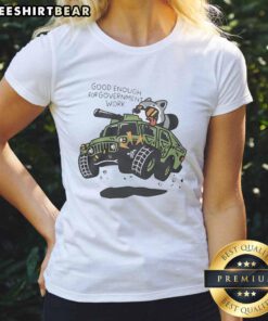 Funny graphic tee featuring a raccoon driving a tank, perfect for casual wear and humorous gifts. Top Raccoon Driving Tank.