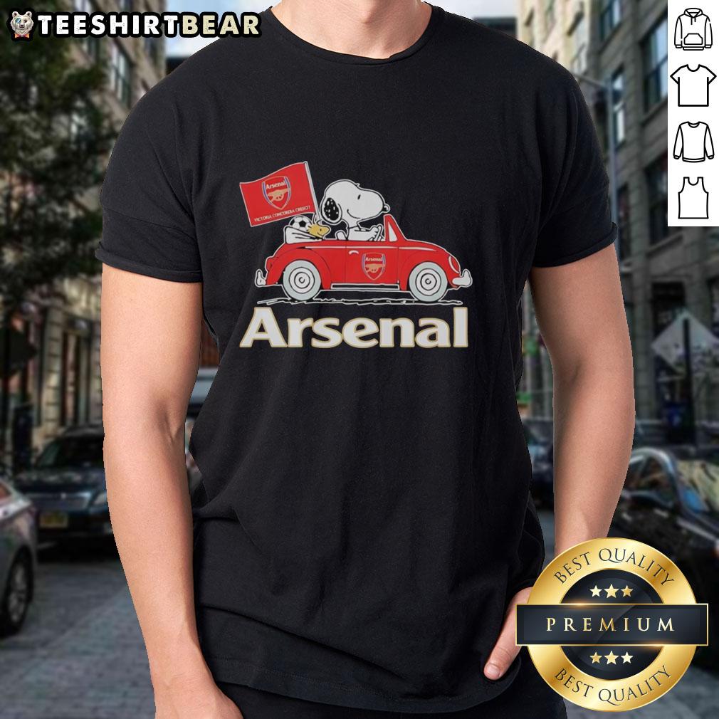 Top Snoopy and Woodstock driving an Arsenal red car, raising a flag on a fun graphic T-shirt design.