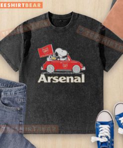 Alt Text: Snoopy and Woodstock driving an Arsenal red car, raising a flag on a stylish washed t-shirt design.