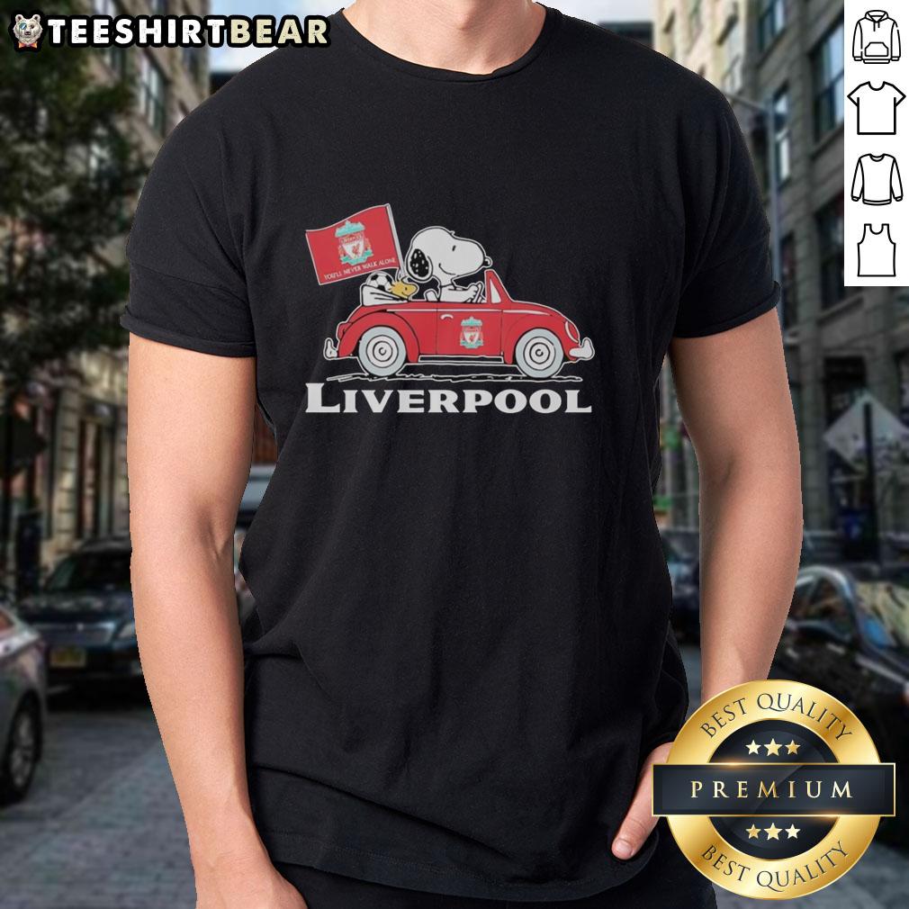 Snoopy and Woodstock in a Liverpool FC red car, raising a flag on a fun t-shirt design for fans.