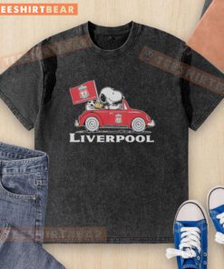 Snoopy and Woodstock driving a Liverpool FC red car, raising a flag on a washed t-shirt design.