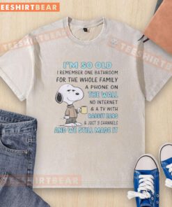 Snoopy graphic t-shirt reading 'I'm So Old I Remember One Bathroom for the Whole Family' with vintage phone design.