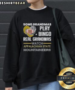Grandmas in cozy sweatshirts enjoying bingo while supporting Appalachian State Mountaineers during game night.