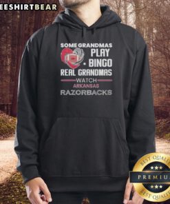 Grandmas in Arkansas wearing Razorbacks hoodies, enjoying a lively game of bingo together.