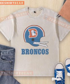Alt Text: Awesome Denver Broncos football logo on a big helmet design featured on a washed t-shirt for fans.