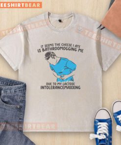 Funny T-shirt design: 'The cheese I ate is bathroomogging me' with playful graphics and humorous text for cheese lovers.