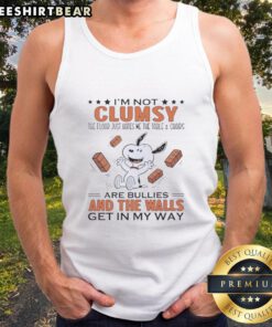 Funny Snoopy tank top design: 'I'm not clumsy, the floor just hates me' with table and chairs illustration.