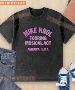 Alt Text: Hot Mike Krol performing live on tour in the USA, wearing a stylish washed T-shirt, energized crowd in the background.