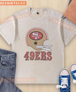 Alt Text: San Francisco 49ers football logo on a big helmet design featured on a washed t-shirt, perfect for fans.