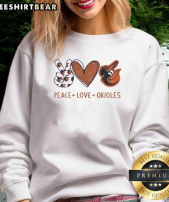 Alt Text: Official Baltimore Orioles sweatshirt featuring a peace love Orioles hand sign in heart shape and logo design.