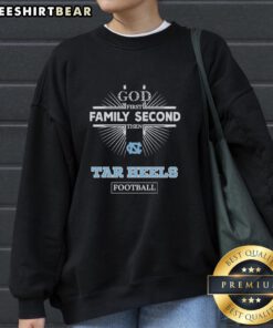 Official North Carolina Tar Heels sweatshirt with 'God First, Family Second, Then Tar Heels Football' slogan.