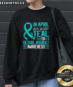Alt Text: Teal sweatshirt with Pretty in April design for Sexual Assault Awareness, featuring a blue ribbon symbol.