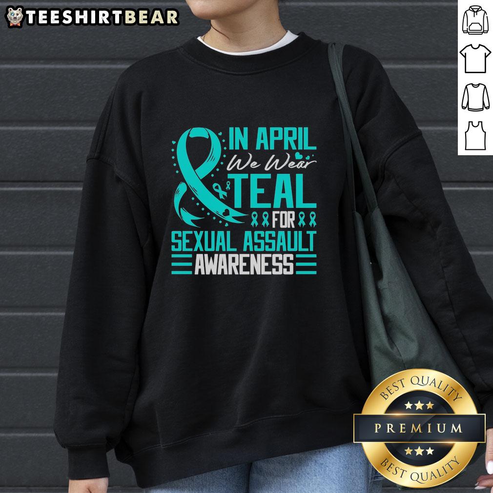 Alt Text: Teal sweatshirt with Pretty in April design for Sexual Assault Awareness, featuring a blue ribbon symbol.