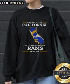Cozy sweatshirt featuring 'I may not live in California but Ill always have the Los Angeles Rams in my DNA' design.