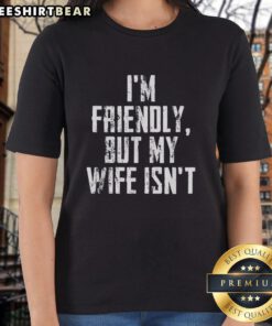 Vintage ladies tee featuring 'Top I'm Friendly But My Wife Isn't' design in a stylish font, perfect for humorous casual wear.