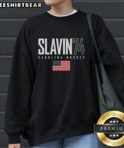 Top Jaccob Slavin 74 Carolina Hurricanes USA Flag Elite Sweatshirt featuring team colors and logo.