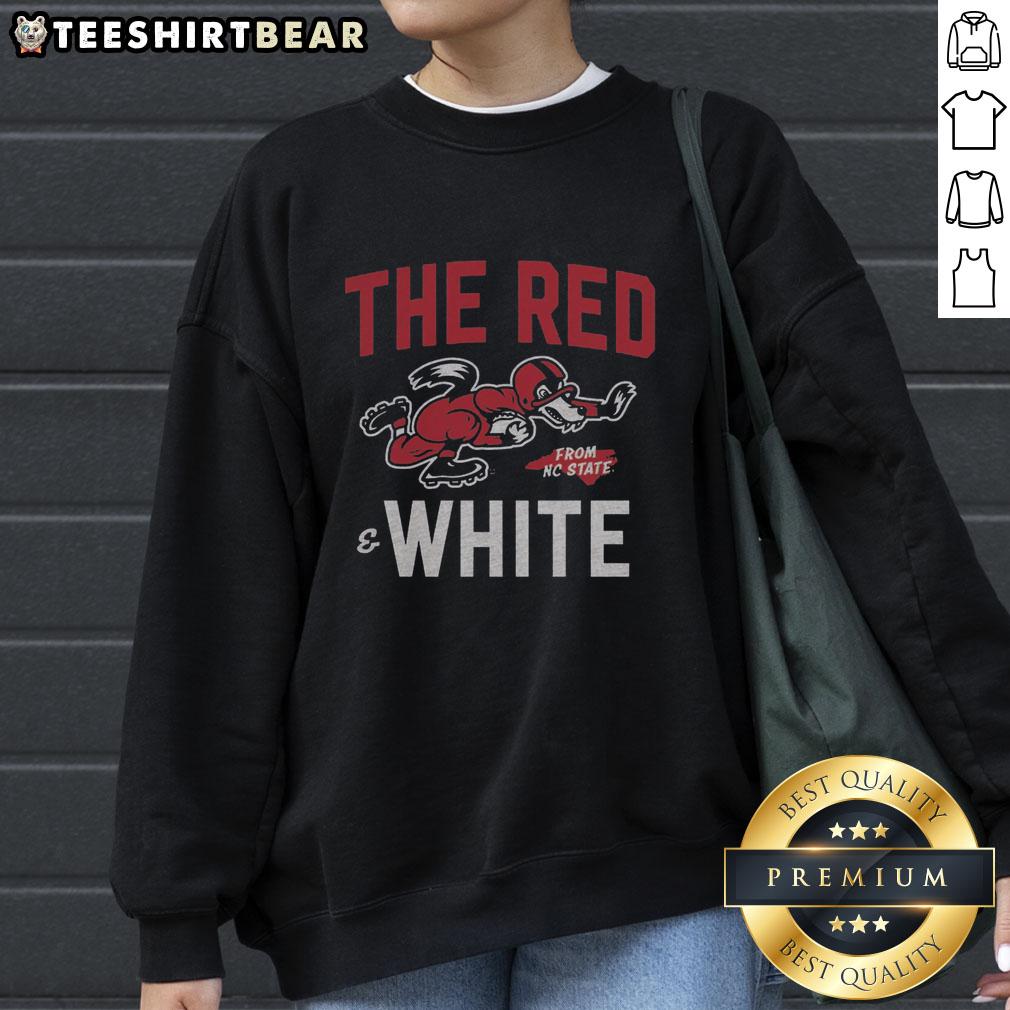 Top the Red and White NC State football sweatshirt displayed on a hanger, showcasing team colors and logo.