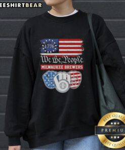 Alt Text: Milwaukee Brewers sweatshirt featuring 'We The People' and 'American Since 1776' designs, perfect for fans.
