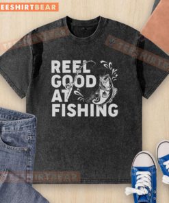 Awesome Reel Good at Fishing washed t-shirt displayed on a wooden background, perfect for fishing enthusiasts.