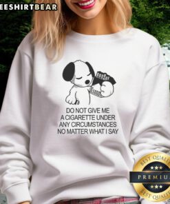 Cute Snoopy holding a cigarette on a 'Do Not Give Me A Cigarette' sweatshirt, perfect for dog lovers and Peanuts fans.