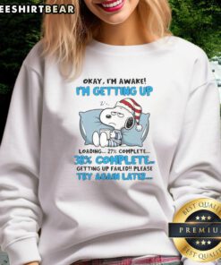 Alt Text: Cute Snoopy sweatshirt featuring 'Okay, I'm Awake' loading graphic, perfect for casual wear and Snoopy fans.