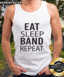 Alt Text: Musician wearing a Nice Band Eat Sleep Repeat tank top while marching, showcasing a vibrant music lifestyle.