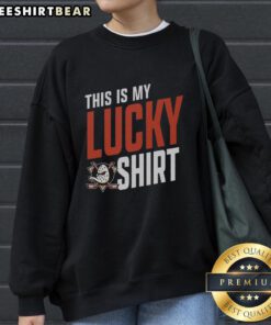 Young fan wearing a lucky Anaheim Ducks sweatshirt, showing team spirit at a hockey game, smiling with excitement.