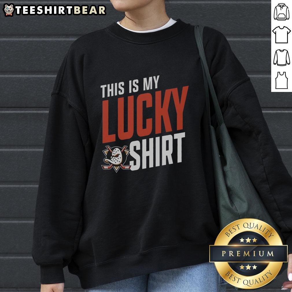 Young fan wearing a lucky Anaheim Ducks sweatshirt, showing team spirit at a hockey game, smiling with excitement.