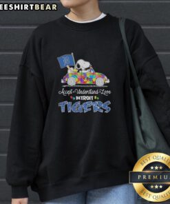 Pretty Snoopy and Woodstock driving a car on a Detroit Tigers sweatshirt promoting autism acceptance and love.