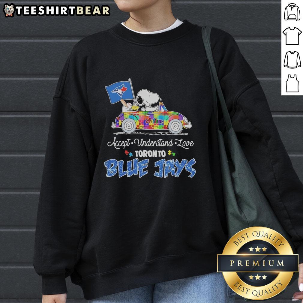 Cute Snoopy and Woodstock driving a car on a Toronto Blue Jays sweatshirt promoting autism acceptance and love.