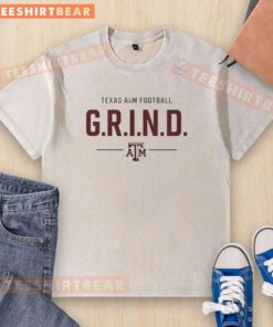 Alt Text: Pretty Texas AM Football G.R.I.N.D. logo washed t-shirt showcasing team spirit and casual style.